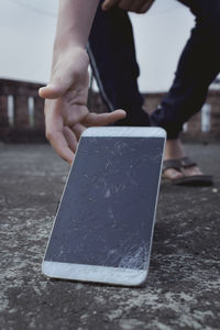 Close-up of hand holding broken glass