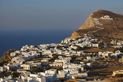 High angle view of townscape by sea against sky