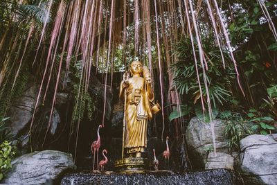 Statue of buddha against trees