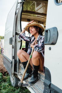 Full length of woman sitting in motor van