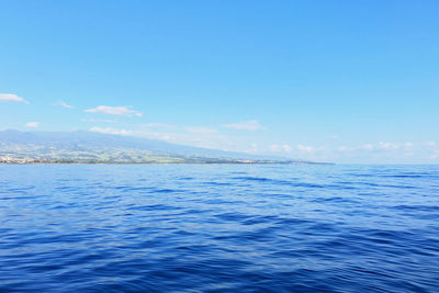 Scenic view of sea against blue sky