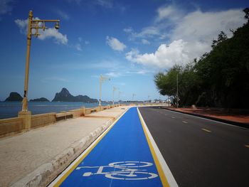 Road by sea against sky