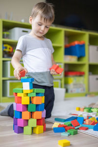 Close-up of cute boy playing with toys