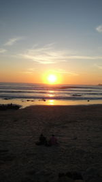 Scenic view of beach against sky during sunset