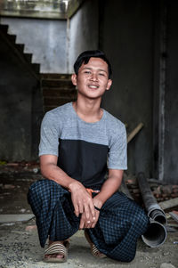 Portrait of young man sitting outdoors