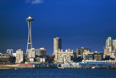 Modern buildings in city against blue sky