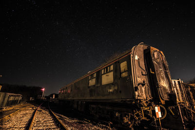 Abandoned train against night sky