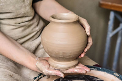 Potter holds just hired by pitcher. ceramic skills. sculptor sculpts products from white clay. 