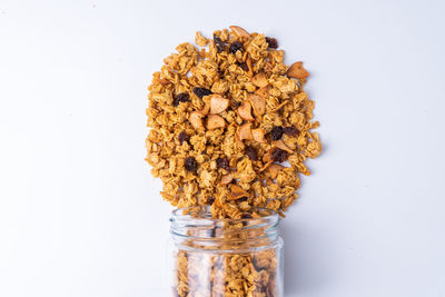 Close-up of glass jar against white background