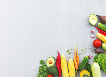 Flat lay with different vegetables, fruits, berries, nuts, spices, herbs, olive oil. copy space area