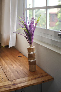 Close-up of purple flower vase on table