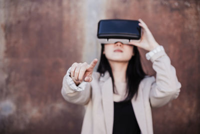 Chinese businesswoman using virtual reality headset. selective focus on hands. technology