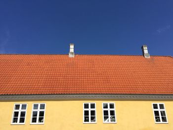 Low angle view of building against clear blue sky