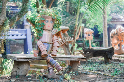 Statues on field against trees