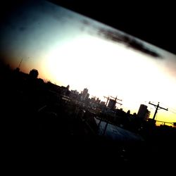 Low angle view of built structure against sky at sunset