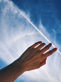 Low angle view of hand against sky