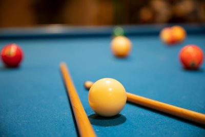 Macro photography of snooker, billiard balls, pool game table, cue ball, striped ball, pool stick