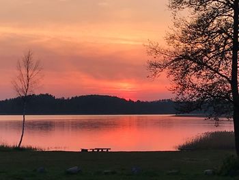 Scenic view of lake against orange sky