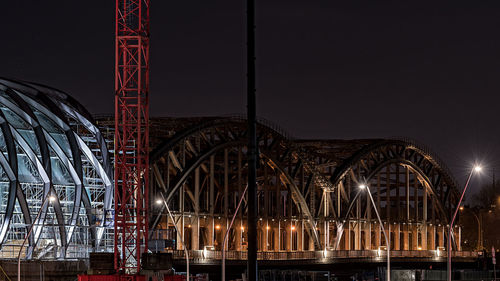 Illuminated ferris wheel against sky at night