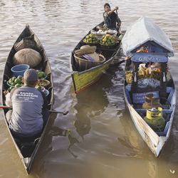 High angle view of woman sitting in boat