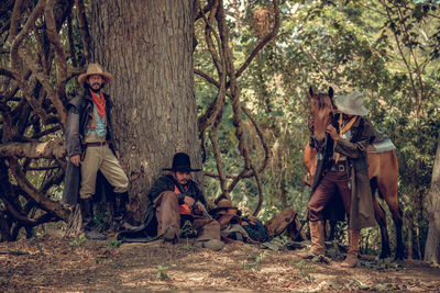 Male friends resting in forest