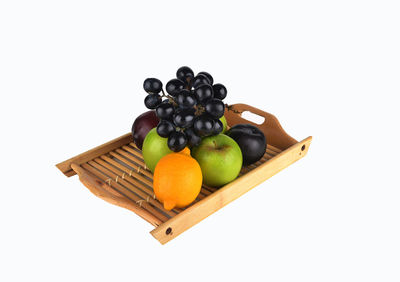 High angle view of fruits in basket on white background