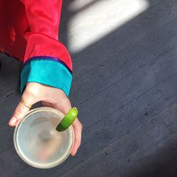 Low section of child holding umbrella