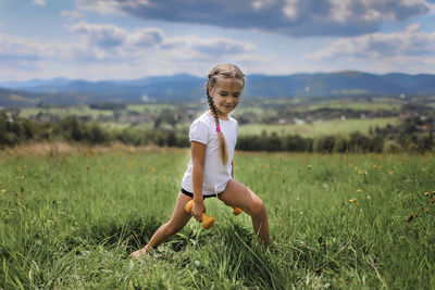 Full length of boy on field against sky