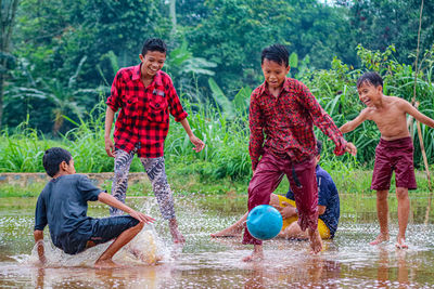 Rear view of people playing soccer