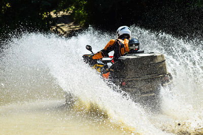 People in boat on river