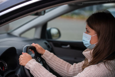 Portrait of woman sitting in car