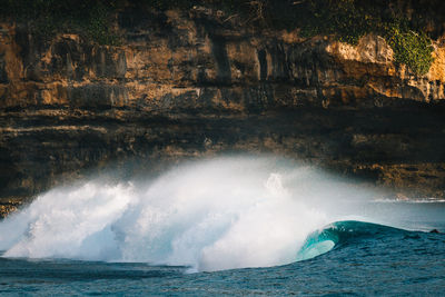 Waves on sea against rock formation