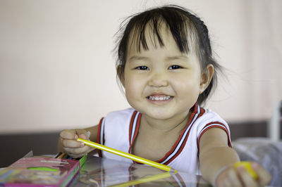 Portrait of smiling boy on table