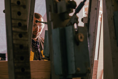 Close-up of man standing by door