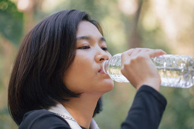 Close-up of young woman drinking water