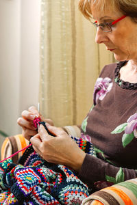 Midsection of woman holding mobile phone