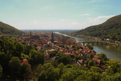 High angle view of townscape by river against sky