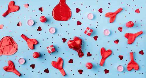 Valentines day. red decorations balloons, candles, confetti and gifts top view flat lay 