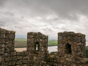 Old ruins of building against cloudy sky