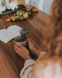 Woman holding coffee cup on table