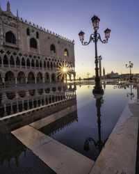 Reflection of street light on water in city