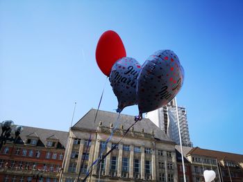 Low angle view of buildings against blue sky