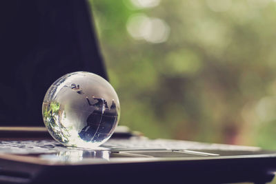 Close-up of crystal ball on glass