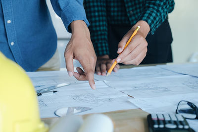 Low section of people working on table