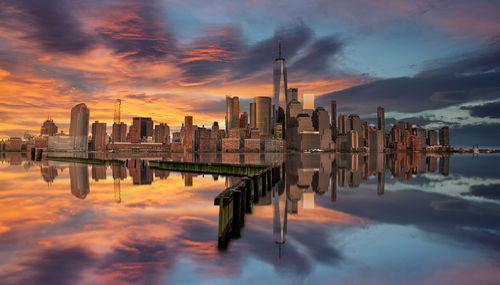 Panoramic view of buildings against cloudy sky during sunset