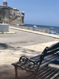 Metal structure on beach against sky