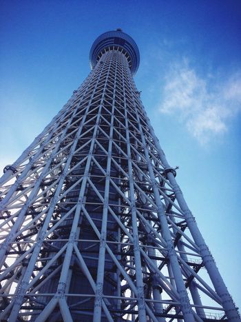 Low angle view of communications tower against blue sky