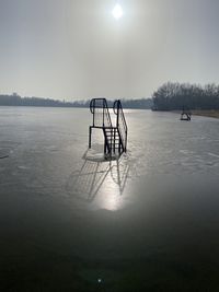 Scenic view of frozen lake against sky during winter