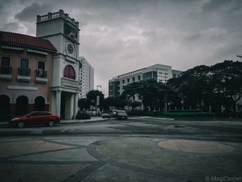 City street by buildings against sky