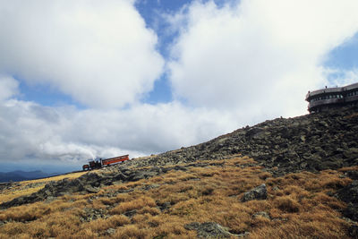 Steam locomotive pushing up coach close to the summit of of mount washington at good weather